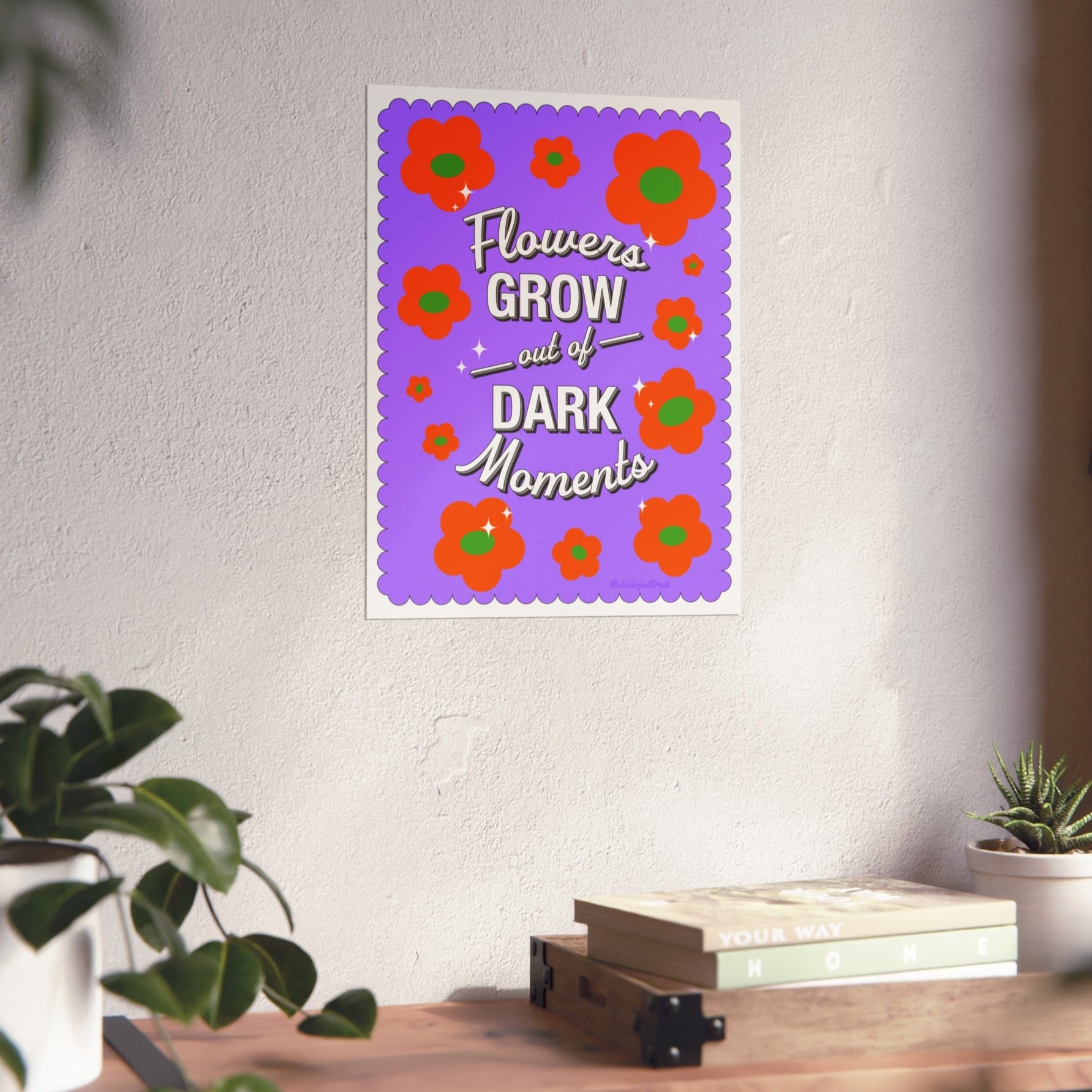 Decorative wall poster with floral design and motivational quote on a white wall.