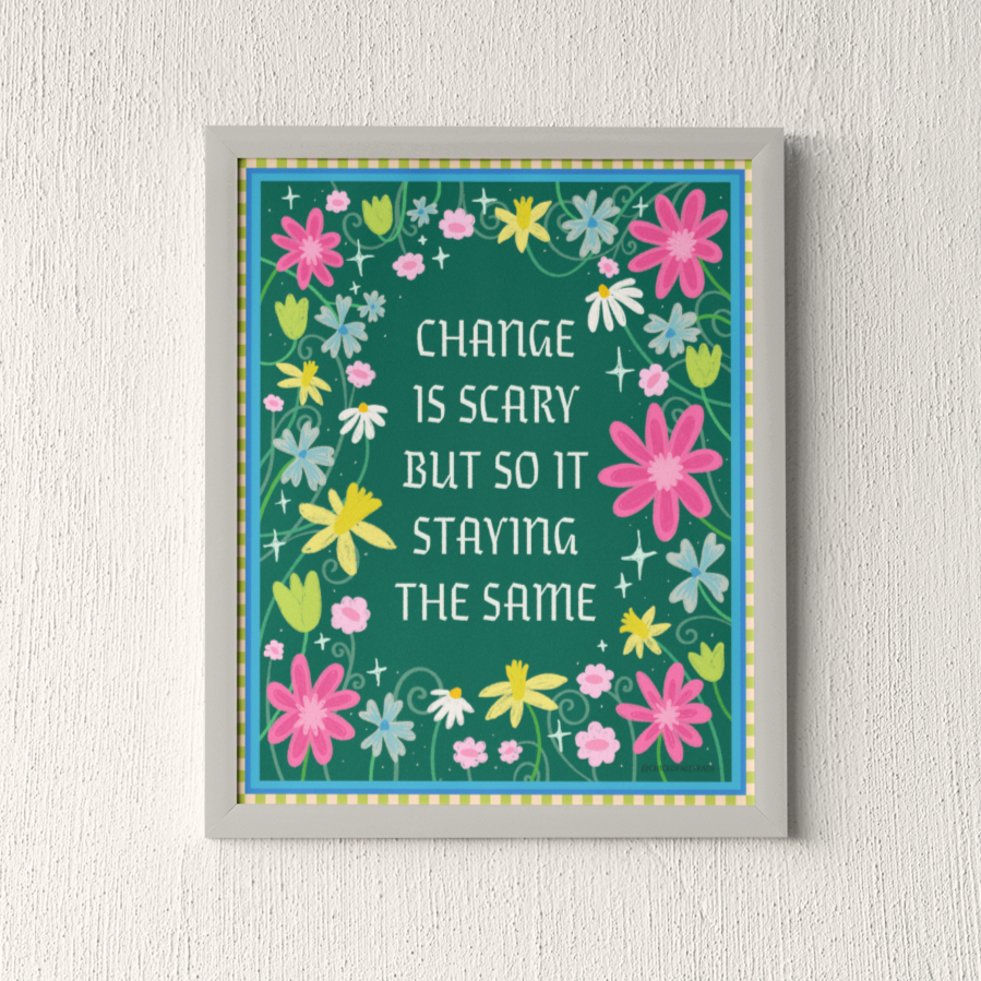Framed artwork with floral design and motivational quote on a white wall