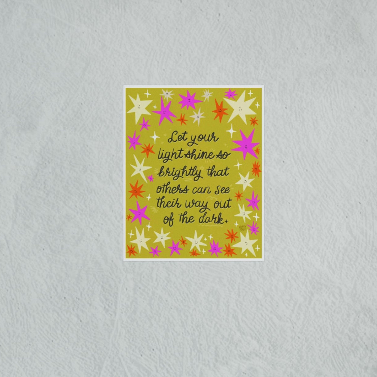 Decorative wall art with floral design and inspirational quote on a textured wall.
